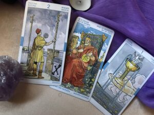 In the picture we see 3 Tarot cards.