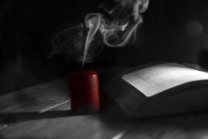 The photo shows a candle and a book.