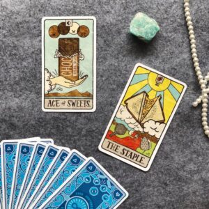 The picture shows Tarot cards and a crystal used in magic.